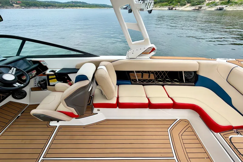 Slide: The Image of 2018 Nautique Super Air Nautique GS24 interior with luxurious seating and modern dashboard. - 30