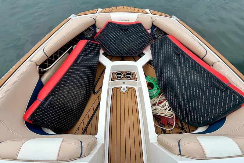 Slide: The Image of 2018 Nautique Super Air Nautique GS24 boat interior with seating and storage compartments. - 32