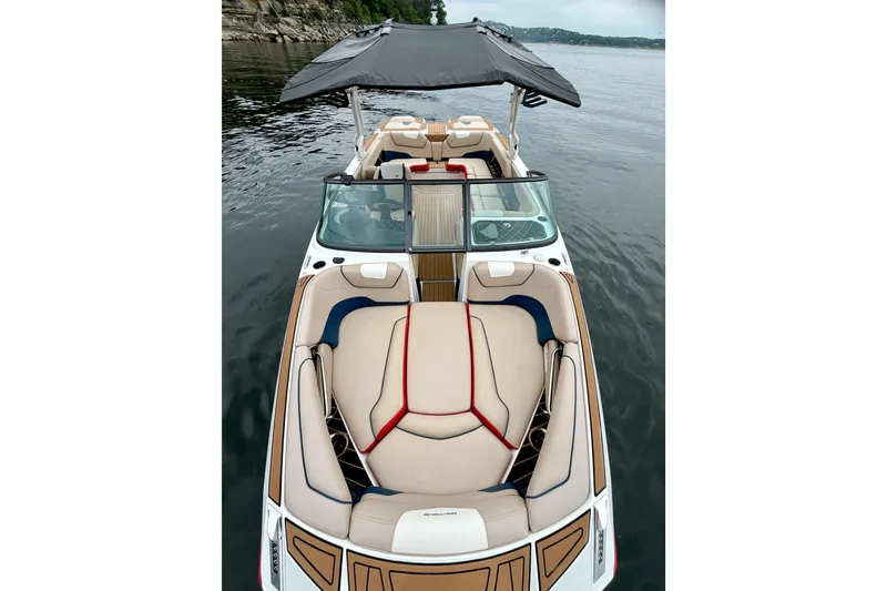 Slide: The Image of 2018 Nautique Super Air Nautique GS24 boat with spacious seating on calm water. - 33
