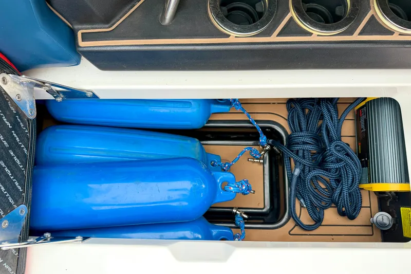 Slide: The Image of Storage compartment of 2018 Nautique Super Air Nautique GS24 with blue fenders and ropes. - 34