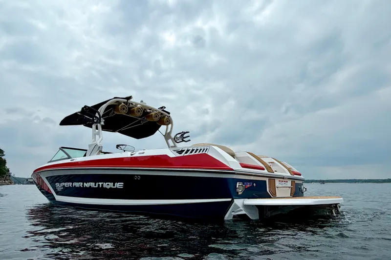Slide: The Image of 2018 Nautique Super Air Nautique GS24 boat on water under cloudy sky. - 7
