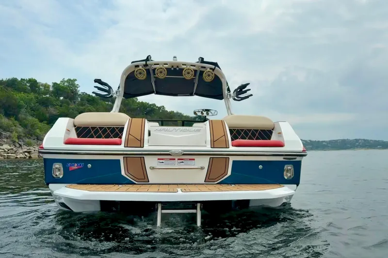 Slide: The Image of 2018 Nautique Super Air Nautique GS24 boat on water, rear view. - 8
