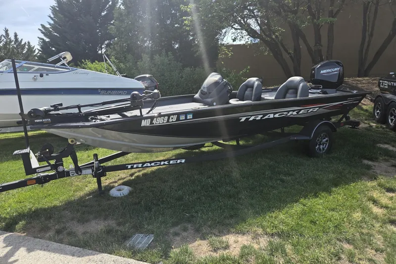 The Image of 2024 Tracker Pro Team 175 TXW boat on trailer, parked on grass. - 1