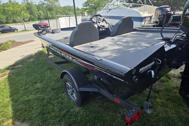 Slide: The Image of 2024 Tracker Pro Team 175 TXW boat on trailer, parked on grass. - 3