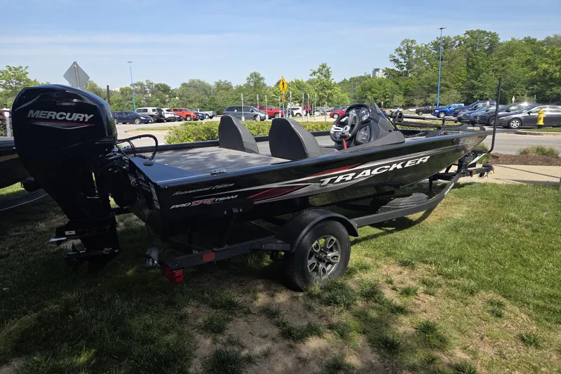 Slide: The Image of 2024 Tracker Pro Team 175 TXW boat with Mercury engine on grassy area. - 5