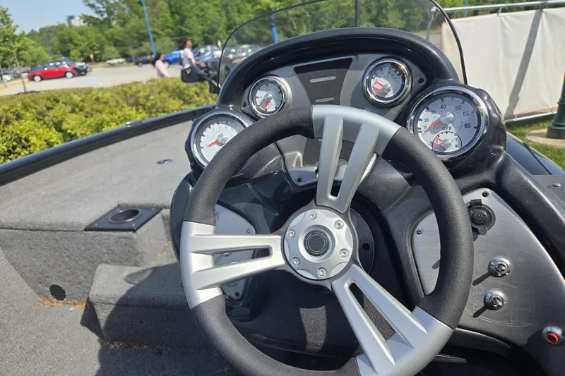 Slide: The Image of 2024 Tracker Pro Team 175 TXW boat dashboard with steering wheel and gauges. - 6