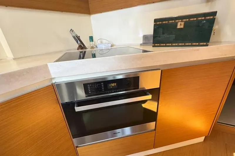 Slide: The Image of Modern kitchen in 2014 Azimut 45 yacht with sleek appliances and wooden cabinetry. - 11