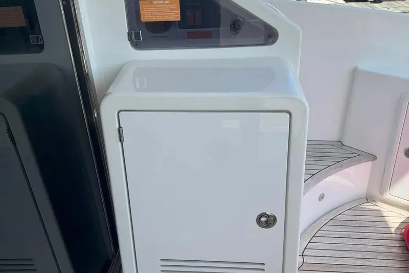 Slide: The Image of White storage cabinet on 2014 Azimut 45 yacht deck with wooden flooring. - 12
