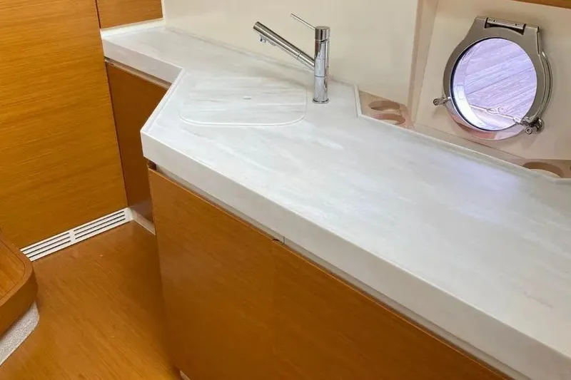 Slide: The Image of Interior of 2014 Azimut 45 yacht with sleek countertop and porthole window. - 14