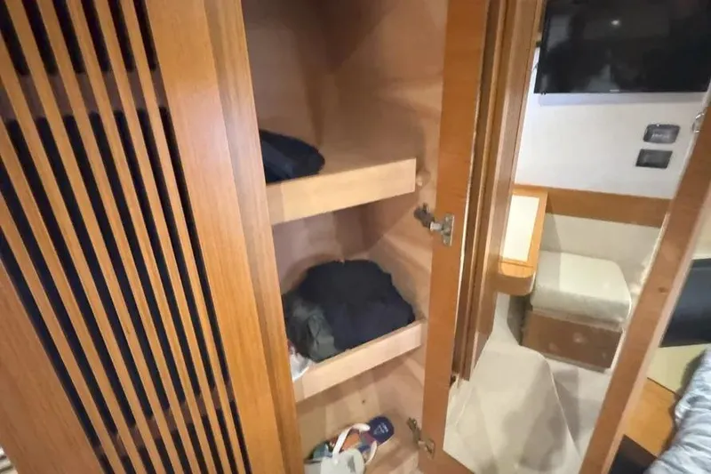 Slide: The Image of Interior of 2014 Azimut 45 yacht showing wooden closet and cabin area. - 22