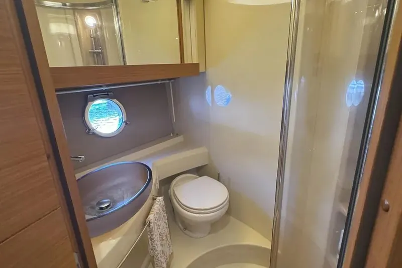 Slide: The Image of Luxurious bathroom in 2014 Azimut 45 yacht with modern fixtures and porthole window. - 27
