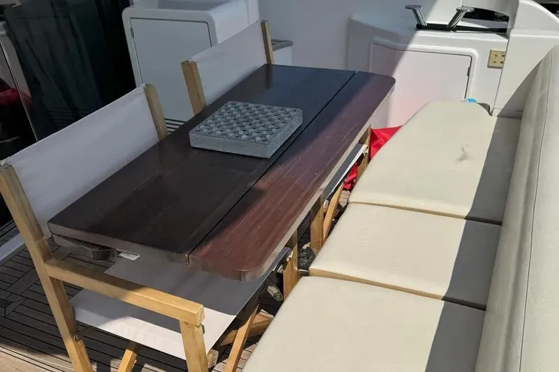 Slide: The Image of Dining area on 2014 Azimut 45 yacht with wooden table and cushioned seating. - 29