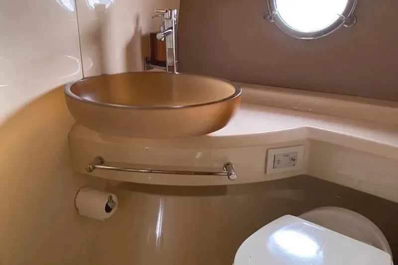 Slide: The Image of Luxurious bathroom interior of 2014 Azimut 45 yacht with modern sink and porthole window. - 34