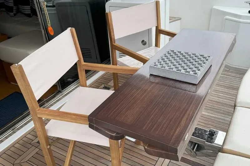 Slide: The Image of Deck seating area on 2014 Azimut 45 yacht with wooden chairs and table. - 35