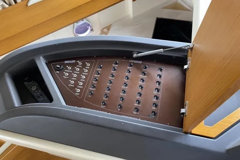 Slide: The Image of Control panel of a 2014 Azimut 45 yacht, featuring multiple switches and a remote control. - 44