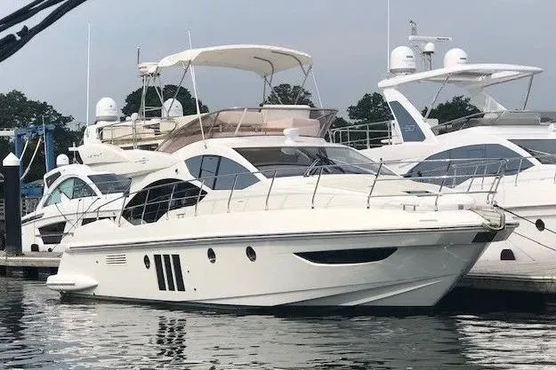 Slide: The Image of 2014 Azimut 45 yacht docked at marina, sleek design, luxury vessel. - 5
