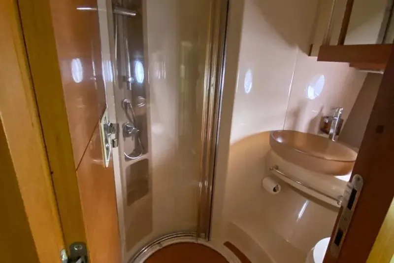 Slide: The Image of Bathroom interior of a 2014 Azimut 45 yacht, featuring a compact shower and sink. - 51