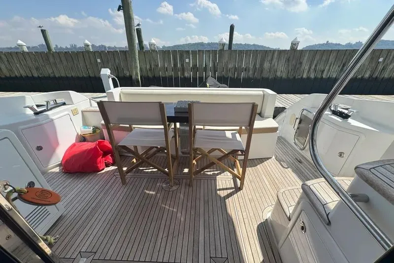 Slide: The Image of Deck of 2014 Azimut 45 yacht with seating and table, docked at marina. - 52