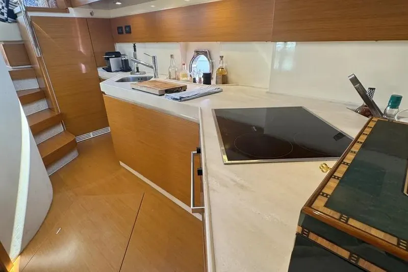 Slide: The Image of Modern kitchen interior on a 2014 Azimut 45 yacht, featuring sleek countertops and appliances. - 56