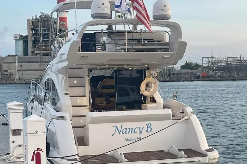 Slide: The Image of Luxury Azimut 45 yacht docked, displaying "Nancy B" name, flags, and marina backdrop. - 57