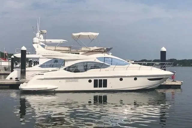 Slide: The Image of 2014 Azimut 45 yacht docked at marina, reflecting on calm water. - 60