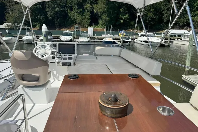 Slide: The Image of Flybridge of 2014 Azimut 45 yacht with helm, seating, and marina view. - 66