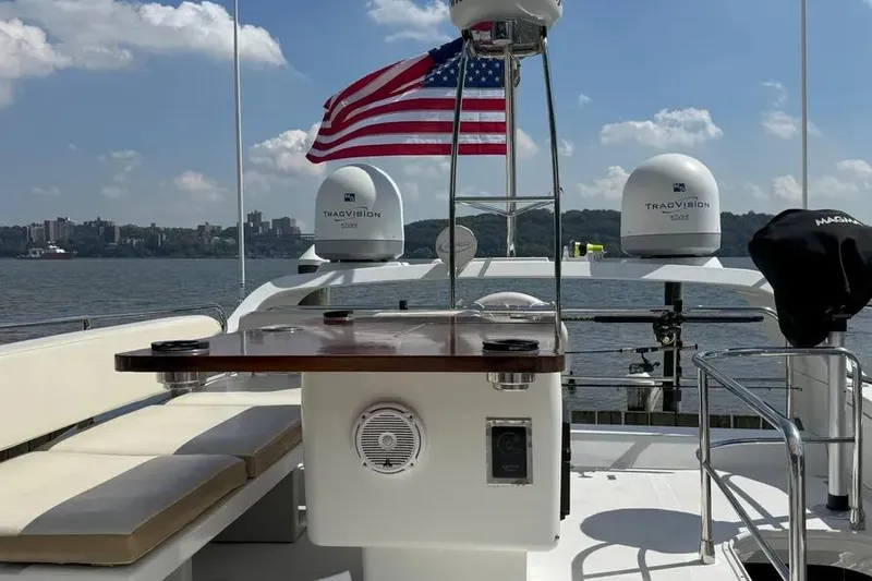 Slide: The Image of Azimut 45 yacht deck with American flag, 2014 model, featuring seating and radar domes. - 69