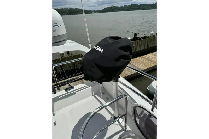 Slide: The Image of 2014 Azimut 45 yacht deck with covered Magma grill by the water. - 70
