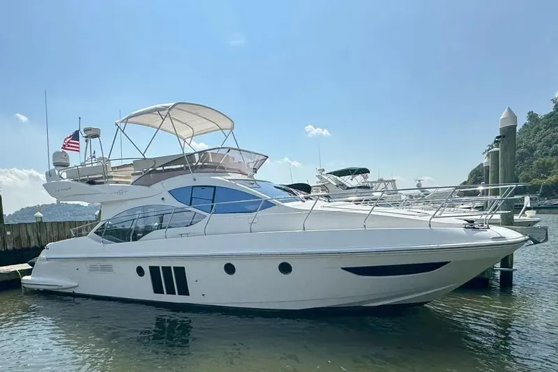 Slide: The Image of 2014 Azimut 45 yacht docked in a marina under a clear blue sky. - 9