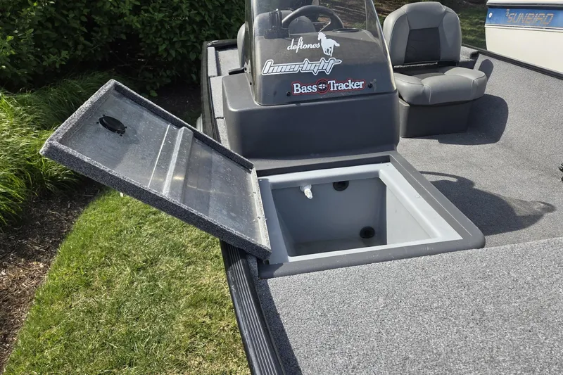 Slide: The Image of 2024 TRACKER MARINE CLASSIC XL boat with open storage compartment and seating. - 10