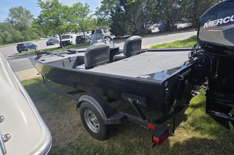 Slide: The Image of 2024 TRACKER MARINE CLASSIC XL boat with Mercury engine on trailer, parked outdoors. - 3
