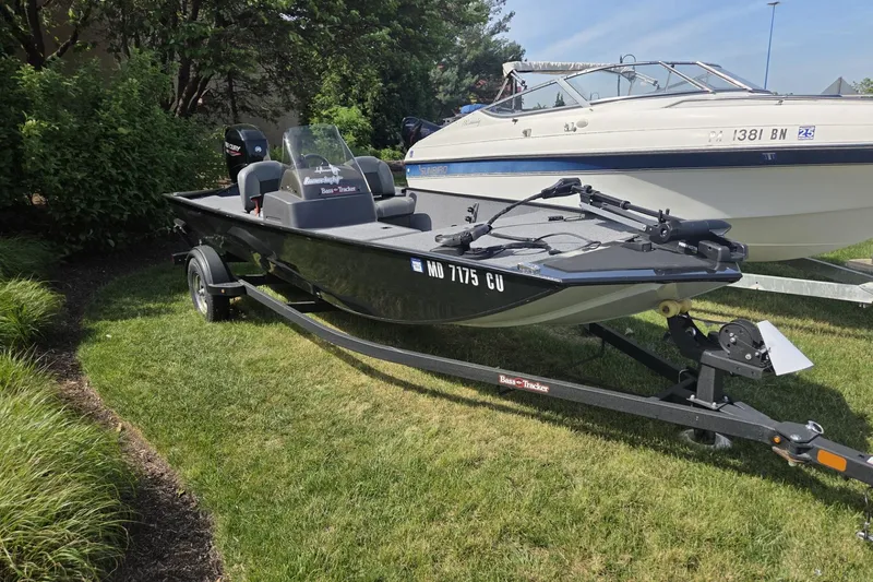 Slide: The Image of 2024 TRACKER MARINE CLASSIC XL boat on trailer, parked on grass. - 4