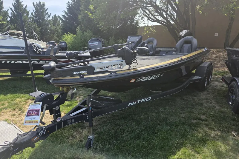Slide: The Image of 2021 Nitro Z19 Pro fishing boat on trailer, displayed outdoors with trees in background. - 4
