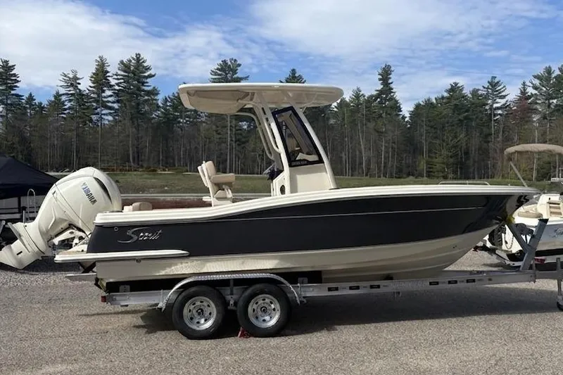 The Image of 2025 Scout 215 XSF boat on trailer, parked outdoors. - 0