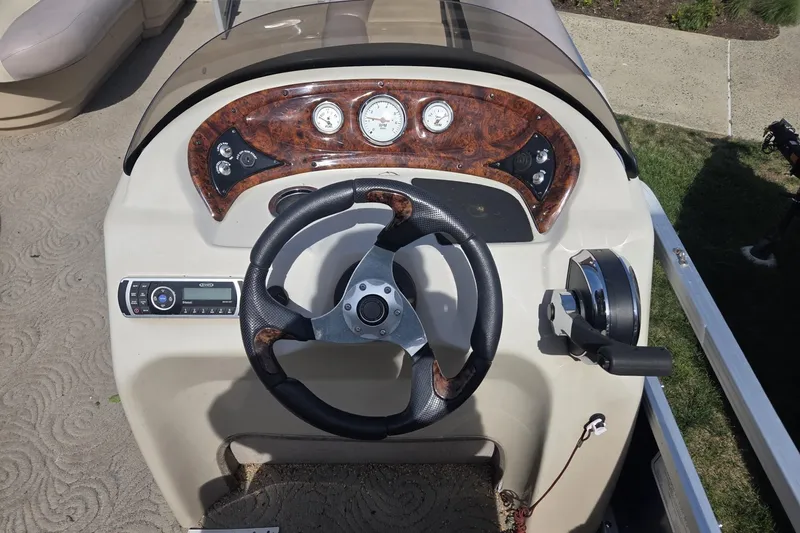 Slide: The Image of 2014 Sun Tracker Party Barge 24 dashboard with steering wheel and control panel. - 8