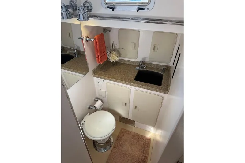 Slide: The Image of Compact bathroom in 2011 Reliance 44 yacht with sink, toilet, and storage cabinets. - 10