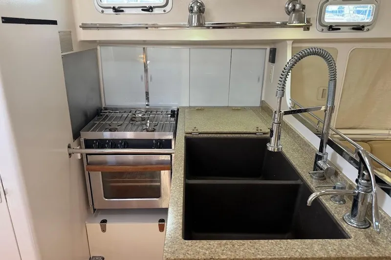 Slide: The Image of Modern kitchen in 2011 Reliance 44 yacht with stove, dual sink, and sleek fixtures. - 11