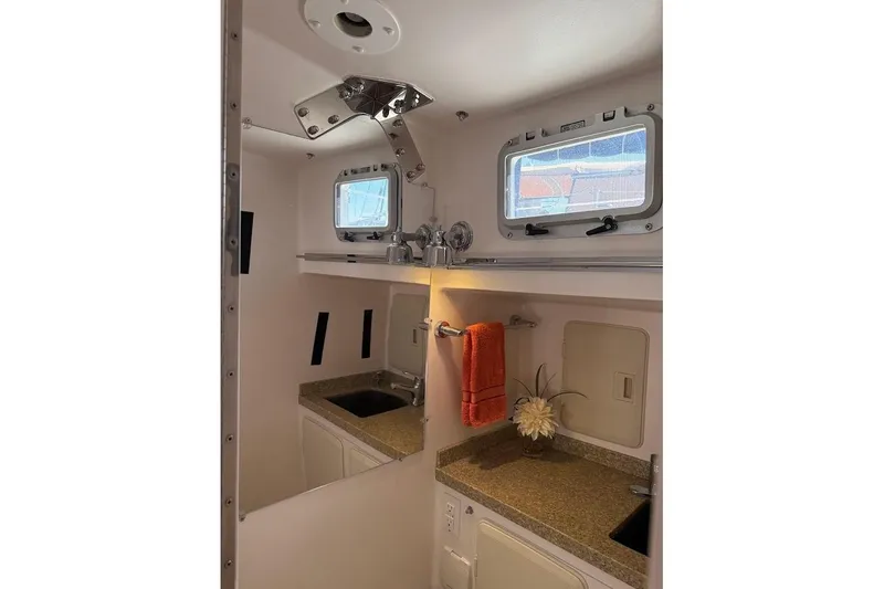 Slide: The Image of Compact bathroom interior of 2011 Reliance 44 yacht with sink, towel, and window. - 14