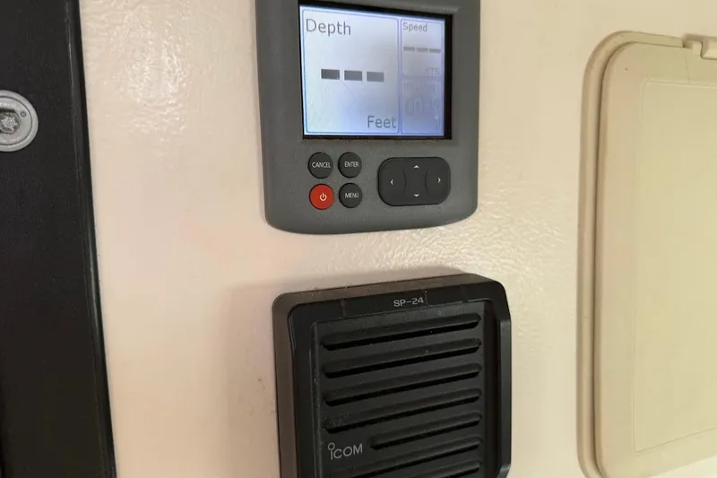 Slide: The Image of Depth gauge and speaker on a 2011 Reliance 44 boat dashboard. - 21