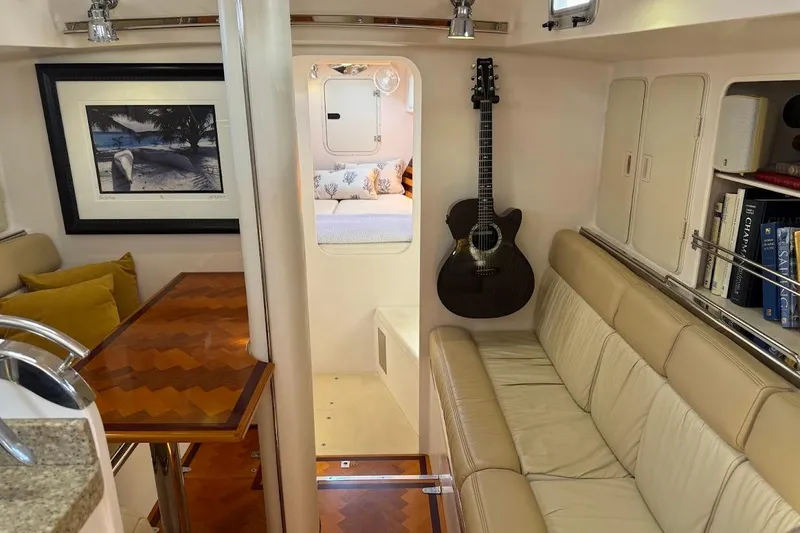 Slide: The Image of Luxurious 2011 Reliance 44 yacht interior with cozy seating, guitar, and elegant decor. - 3