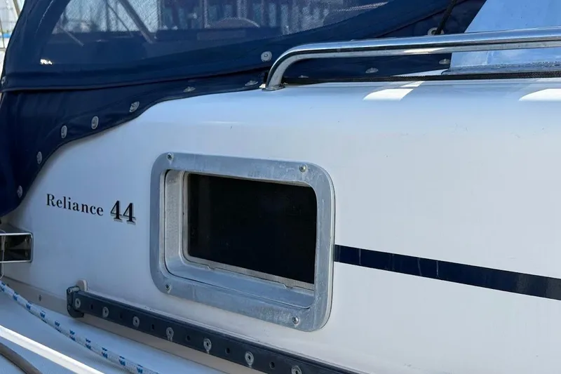 Slide: The Image of Side view of a 2011 Reliance 44 boat with window and blue canopy. - 30