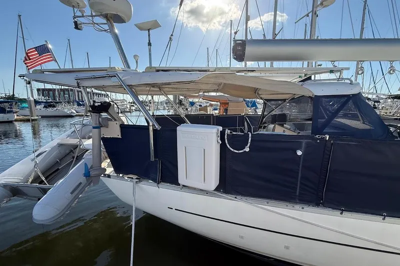 Slide: The Image of Sailboat Reliance 44, 2011 model, docked with American flag, marina background. - 31