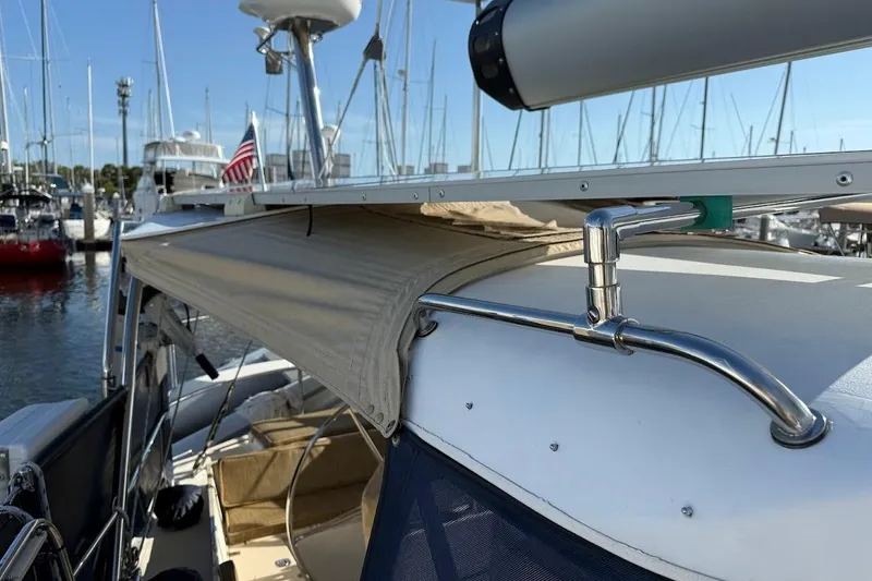 Slide: The Image of Sailboat Reliance 44, 2011 model, docked with sunshade and American flag. - 33