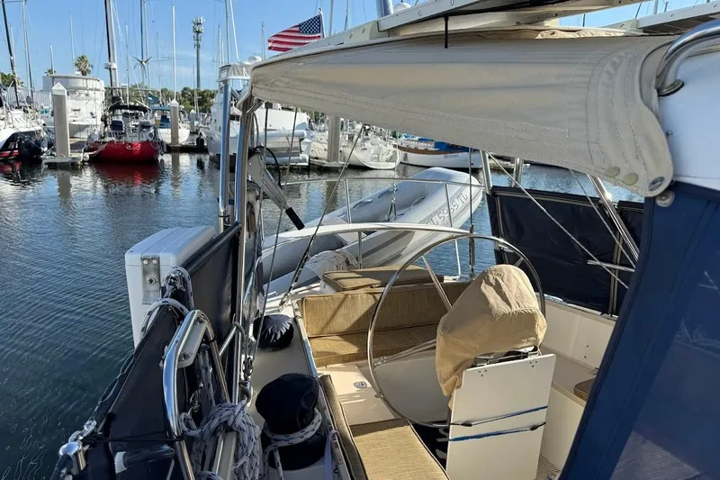 Slide: The Image of Sailboat Reliance 44, 2011 model, docked in marina with American flag. - 34