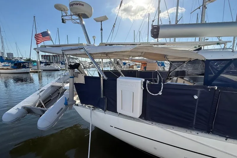 Slide: The Image of Sailboat Reliance 44, 2011 model, docked with American flag and inflatable dinghy. - 38