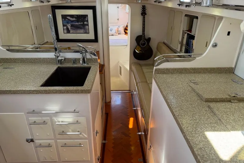 Slide: The Image of Luxurious interior of a 2011 Reliance 44 yacht with modern kitchen and cozy seating area. - 4