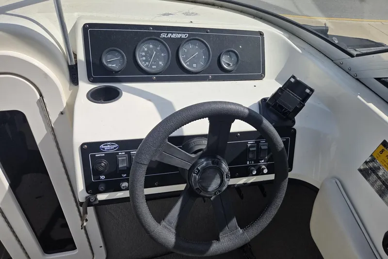 Slide: The Image of 1995 Sunbird Corsair boat dashboard with steering wheel and instrument panel. - 4