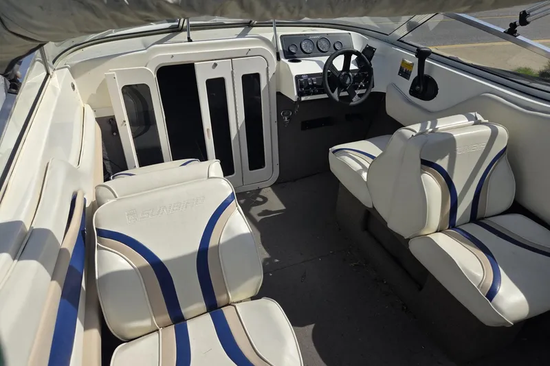Slide: The Image of Interior of a 1995 Sunbird Corsair boat with white and blue seating. - 6