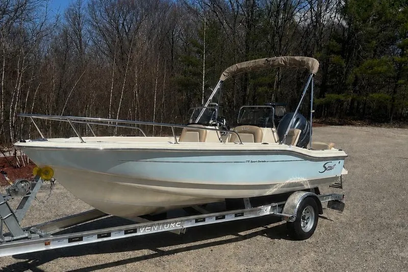 Slide: The Image of 2025 Scout 175 Sport Dorado boat on trailer outdoors. - 1