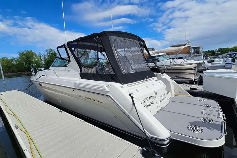 The Image of 1997 Regal Commodore 402 yacht docked at marina under blue sky. - 1